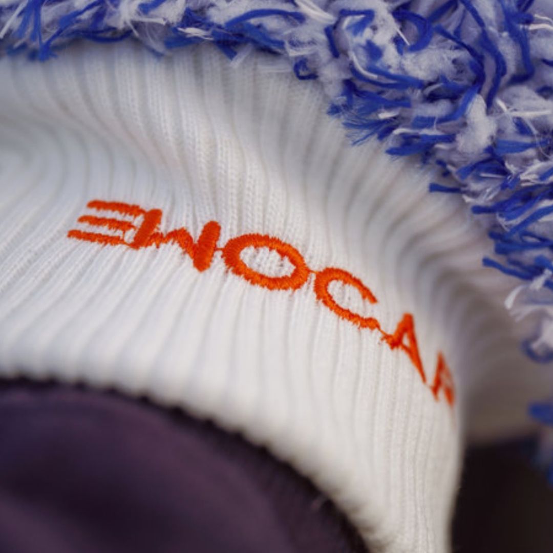 Close-up of a white and blue wash mitt and orange Ewocar branding on a dark background.