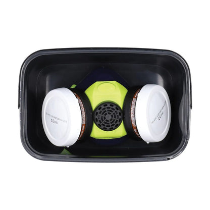 A two-piece respirator mask with a bright lime green central facepiece, black filter cartridges, and a black plastic storage container, shown from a top-down view on a white background.