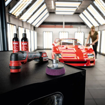 Flex PXE 80 Car polishing tools on a workbench with a red car in the background