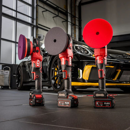 Three Flex polisher attachments on a garage floor with a car in the background
