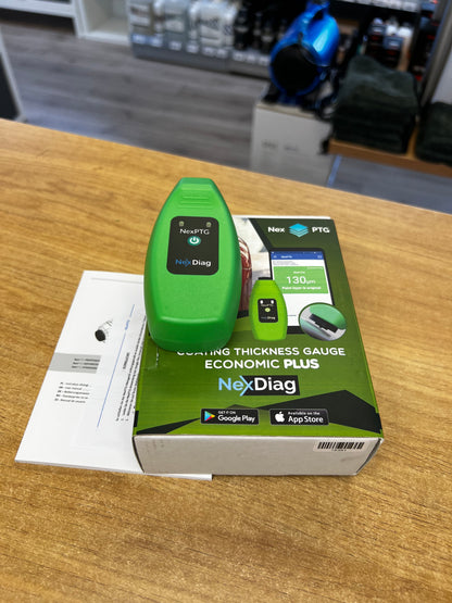 Green thickness gauge with NexDiag box on a wooden surface
