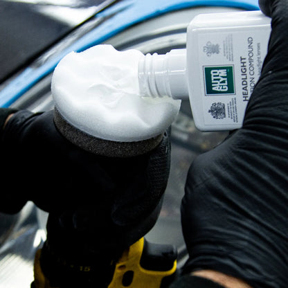 Autoglym Headlight Restoration Kit. White bottle, white applicator and green microfibre cloth