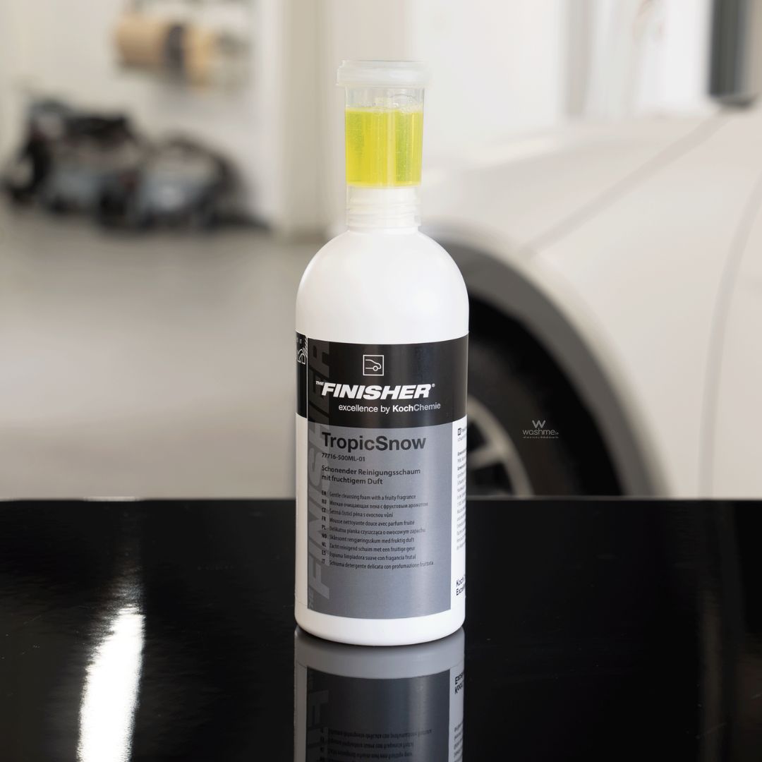 Bottle of Finisher TropicSnow on a car surface with a blurred background