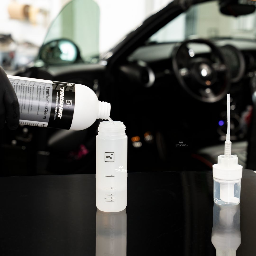 Koch Chemie The Finisher LeatherTexClean product being poured into a bottle with car interior in the background