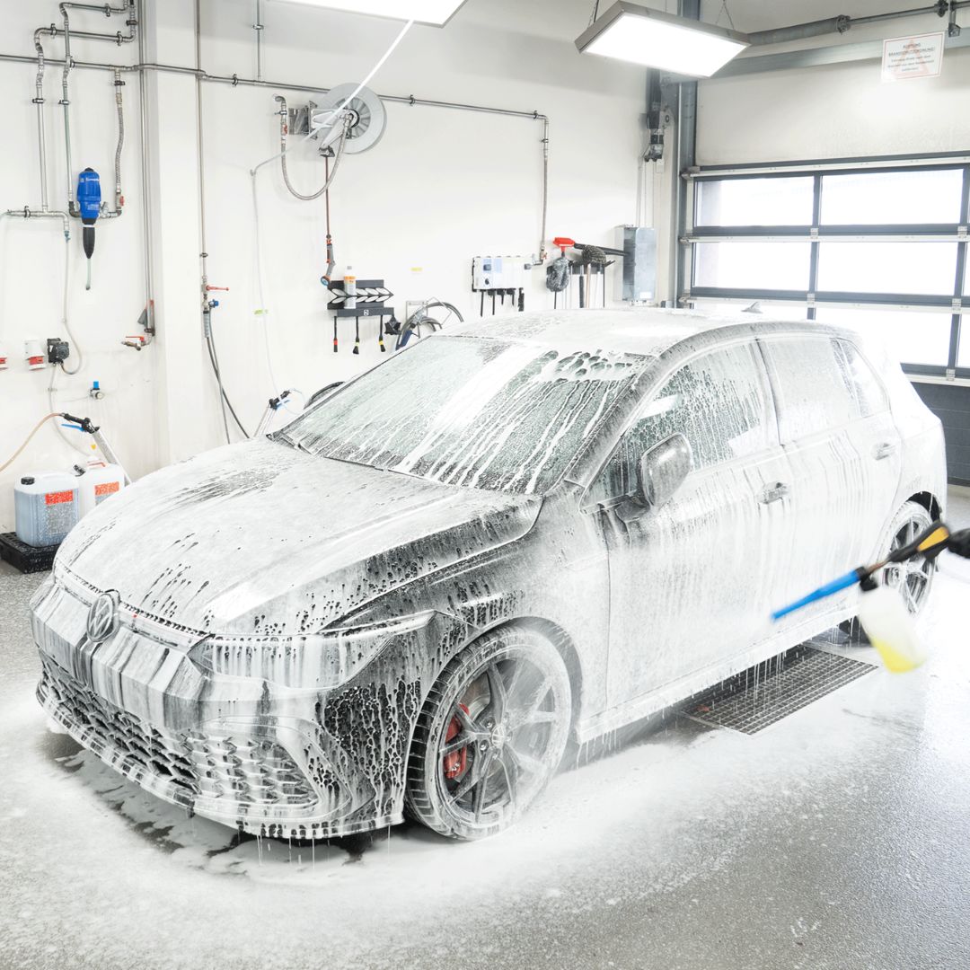 Car being washed with Koch Chemie The Finisher TropicSnow car wash shampoo suds in a professional garage