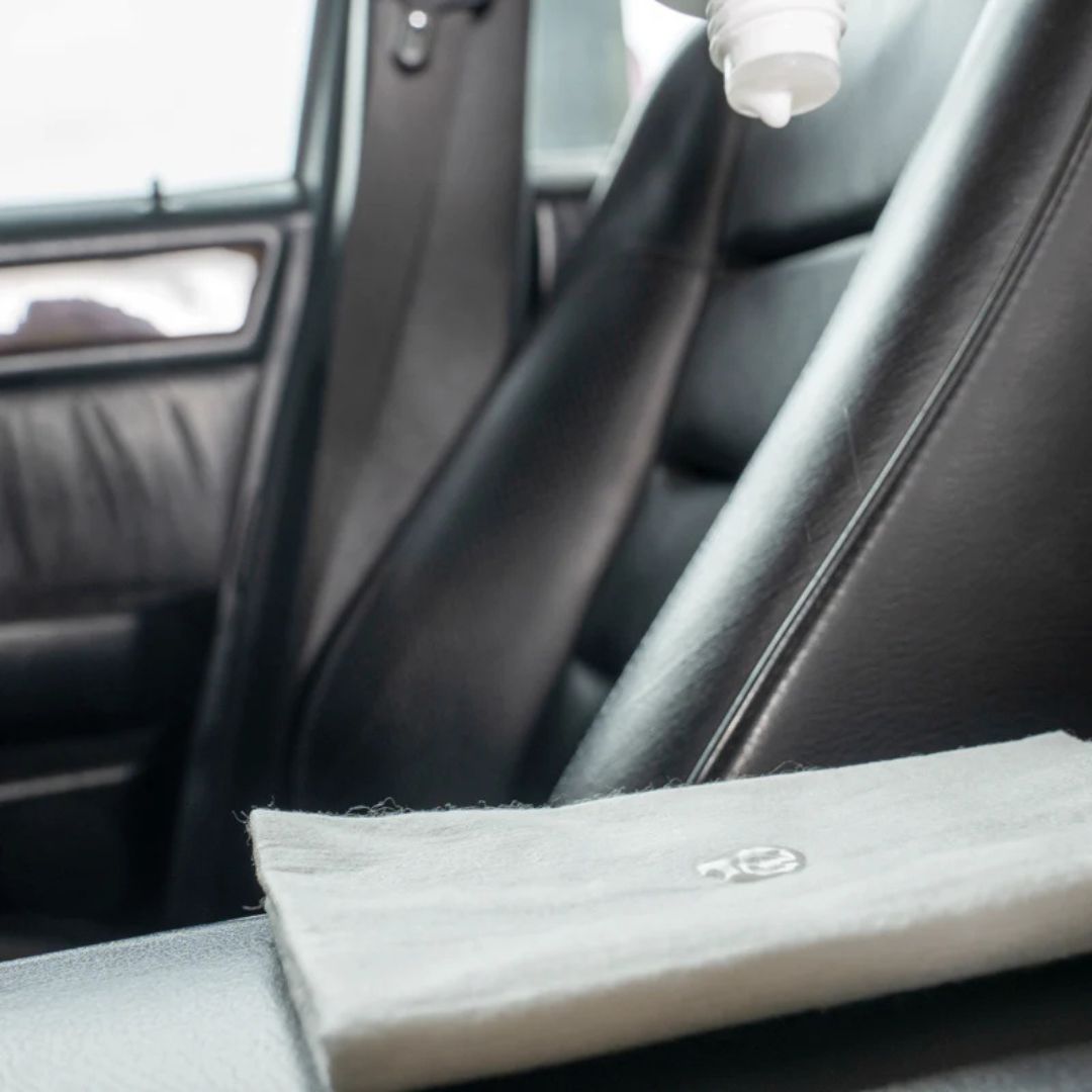 Car interior with a folded gray blanket on the seat