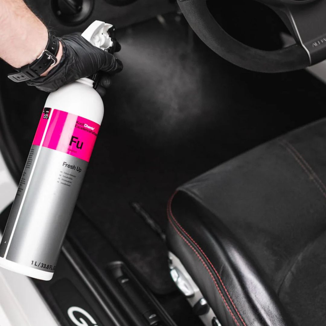 White bottle of Koch Chemie Colourlock FU Fresh Up being sprayed into drivers side footwell of car