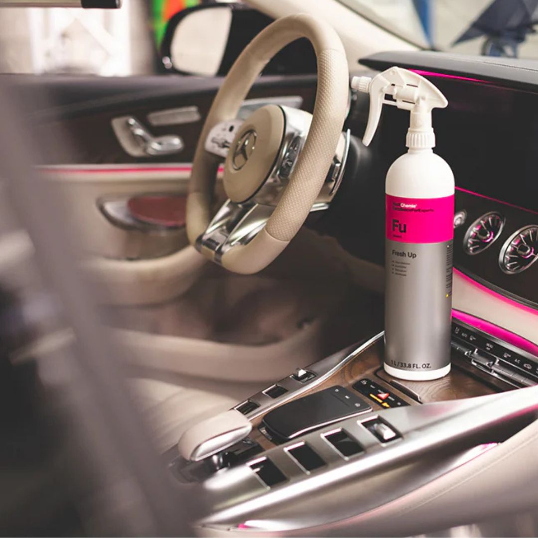 White bottle of Koch Chemie Colourlock FU Fresh Up standing on Mercedes center console