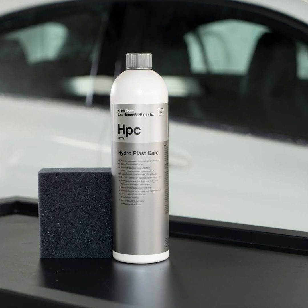 Koch Chemie HPC Hydro Plast Care bottle with a black foam block on a car interior surface.