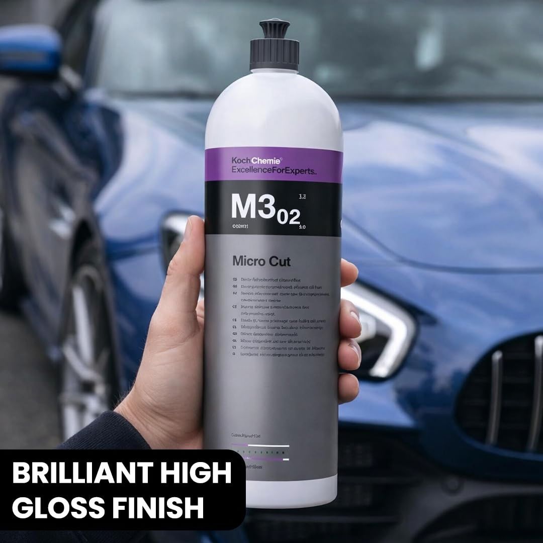 Person holding Koch Chemie Micro Cut M3.02. in his hand in front of a blue Mercedes AMG