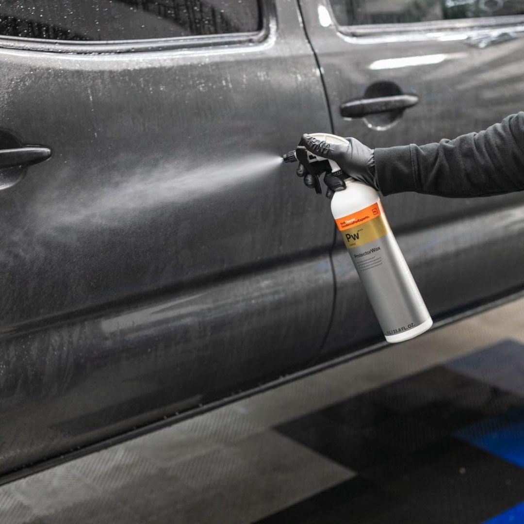 Koch Chemie PW Premium Protector Wax spraying  a car door with a spray bottle