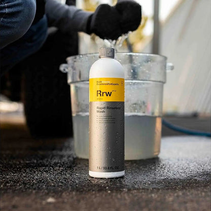 Koch Chemie RRW Rapid Rinseless Wash bottle with a person cleaning a car in the background