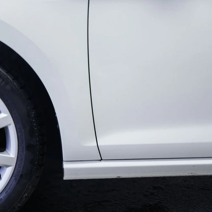 Close-up of a white car's side after removing tar spots with Koch Chemie TEA