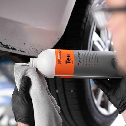 Person applying Koch Chemie TEA product to a car part with a cloth