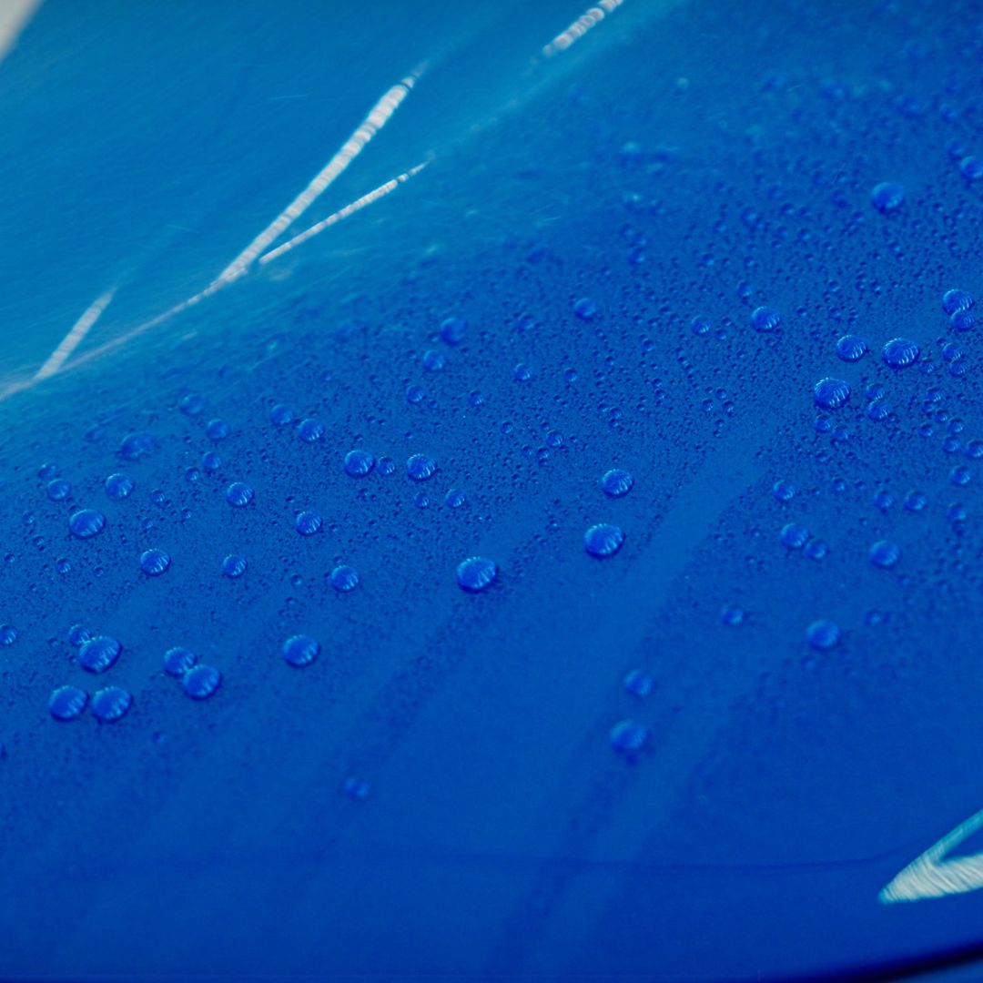 Close-up of water droplets on a blue surface