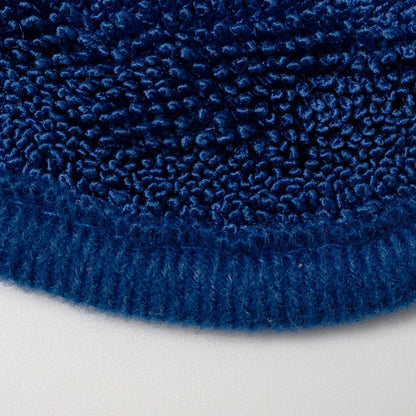 A close-up of a hand wearing a black glove, wiping a glossy blue car body with a textured blue Labocosmetica drying towel.
