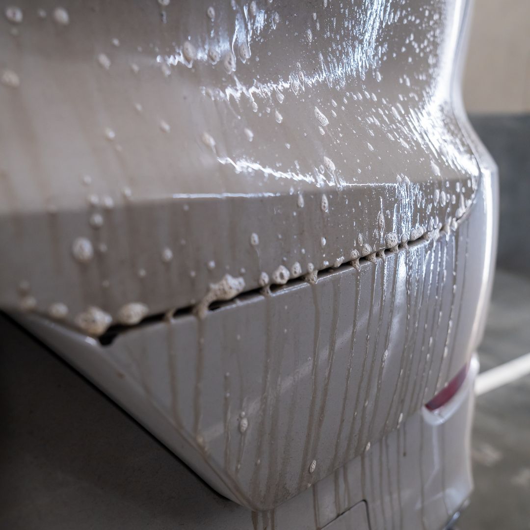 Car with PPF and pre-wash suds in a detailing studio