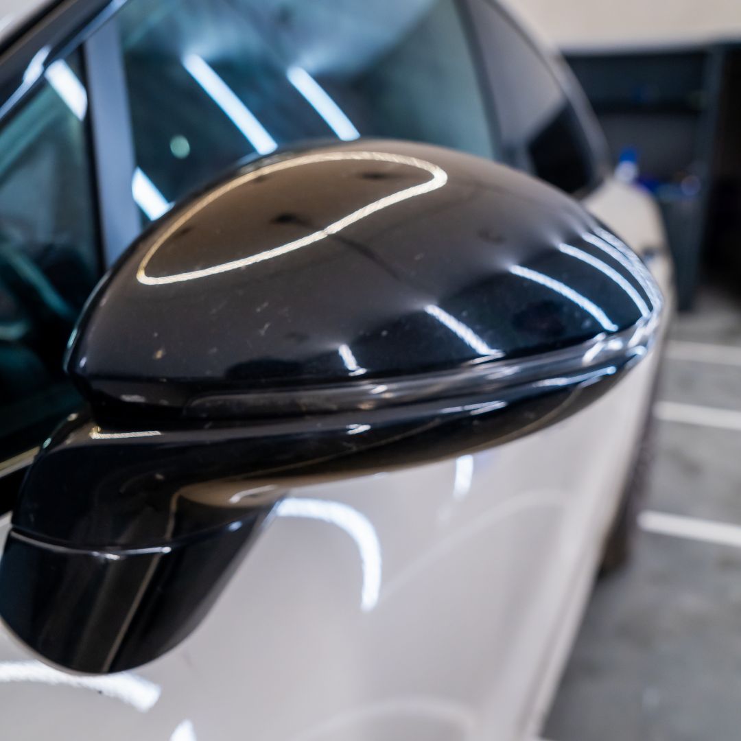 Close-up of a car's black side mirror with PPF 