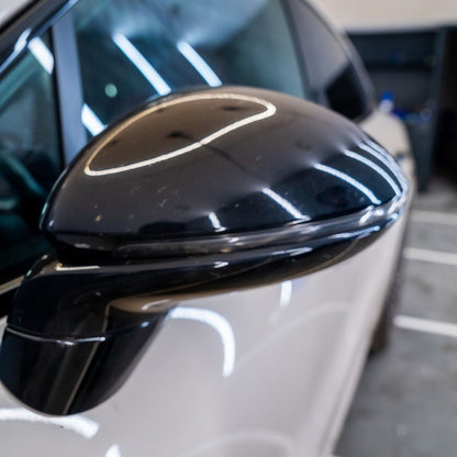 Close-up of a car's black side mirror with PPF 
