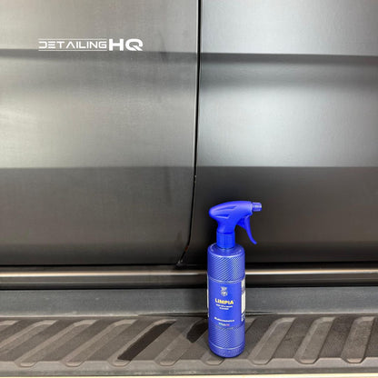 Blue spray bottle on a car's step with 'Detailing HQ' branding.