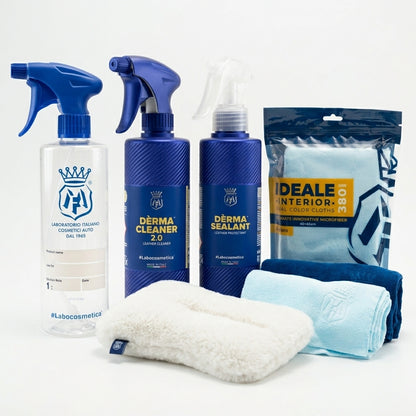 A car care and interior cleaning kit from Labocosmetica, including a clear spray bottle with a blue trigger sprayer, two blue spray bottles labeled Derma Cleaner 2.0 and Derma Sealant, a package of Ideale Interior cloth wipes, and three microfiber cloths in white, light blue, and dark blue, arranged on a white background.