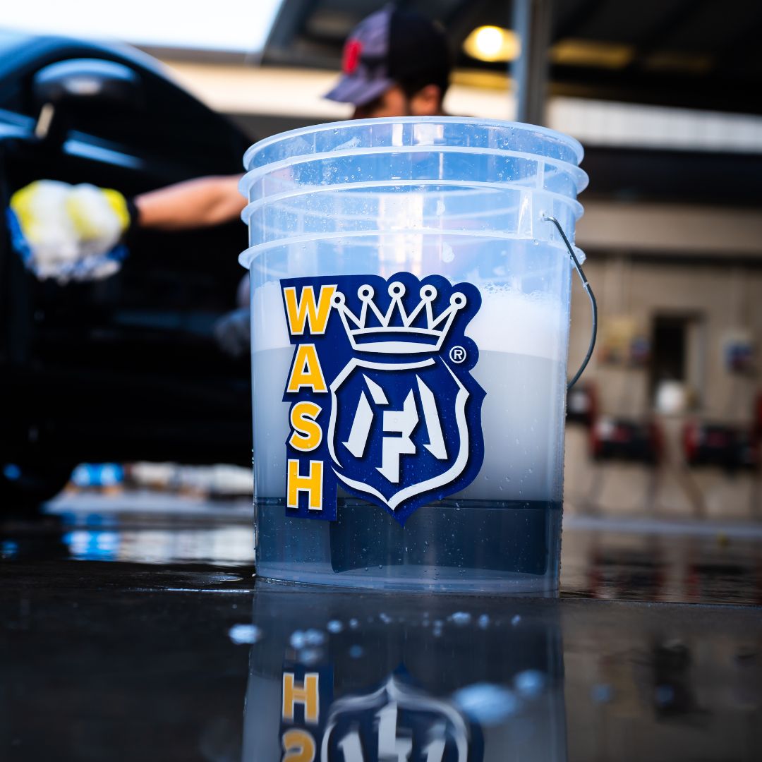 Clear Labocosmetica bucket with a yellow Wash sticker for car wash