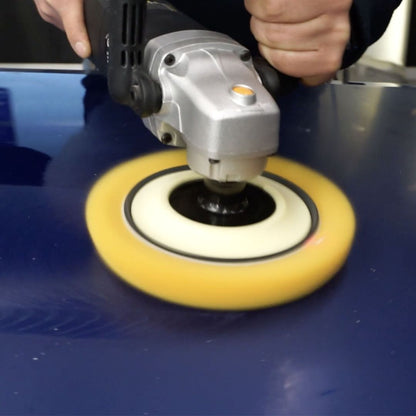 Person using a polisher on a blue car bonnet with a golden, heavy cut wool pad and ShineMate rotary polishing machine