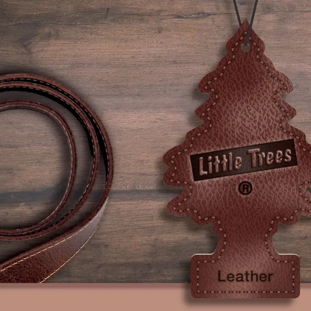 Brown leather 'Little Trees' air freshener on a wooden surface