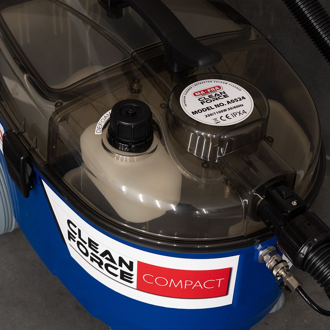 Close-up of a cleaning machine with 'Clean Force Compact' branding.