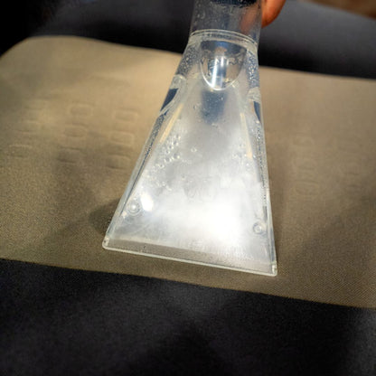 Clear plastic scraper being used on a surface