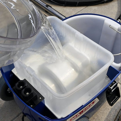 Clear container pouring water into a blue cooler with a visible brand logo.