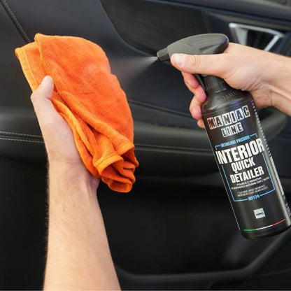 Maniac Interior Quick Detailer sprayed on an orange microfibre cloth