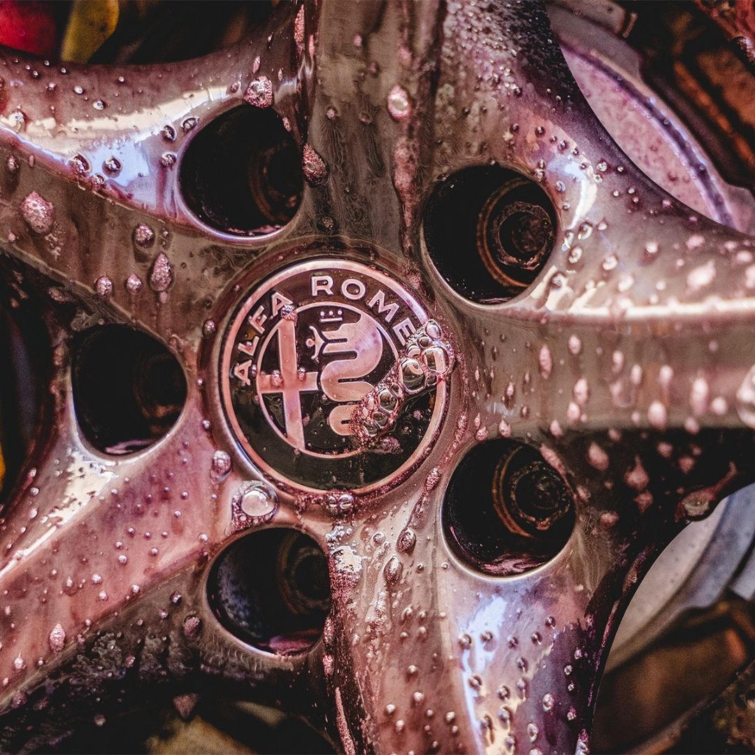 Close-up of a wet wheel with Alfa Romeo logo