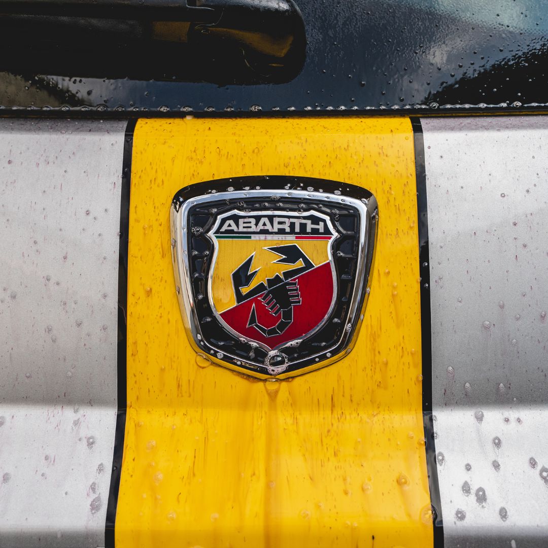 Abarth logo on a car with yellow and black design