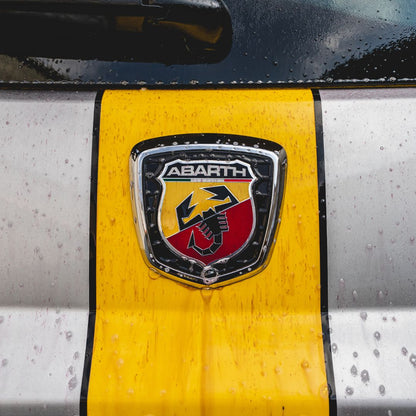 Abarth logo on a car with yellow and black design