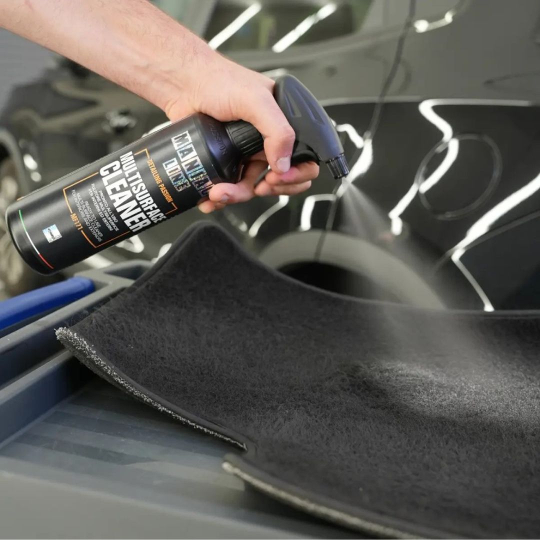 Maniac Multisurface Cleaner sprayed on black car carpet