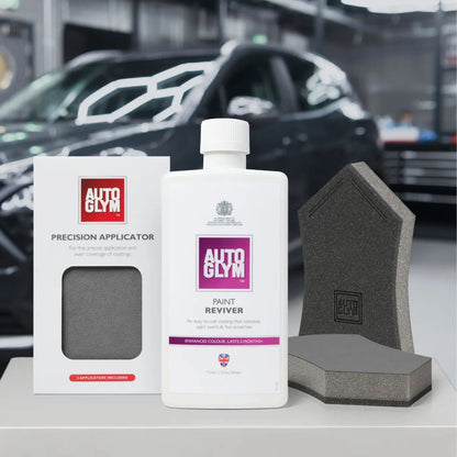 Autoglym car care products including a bottle, applicator, and sponges with a car in the background.