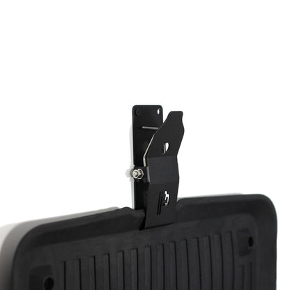 Black Poka Premium mat holder attached to a black car mat on a white background