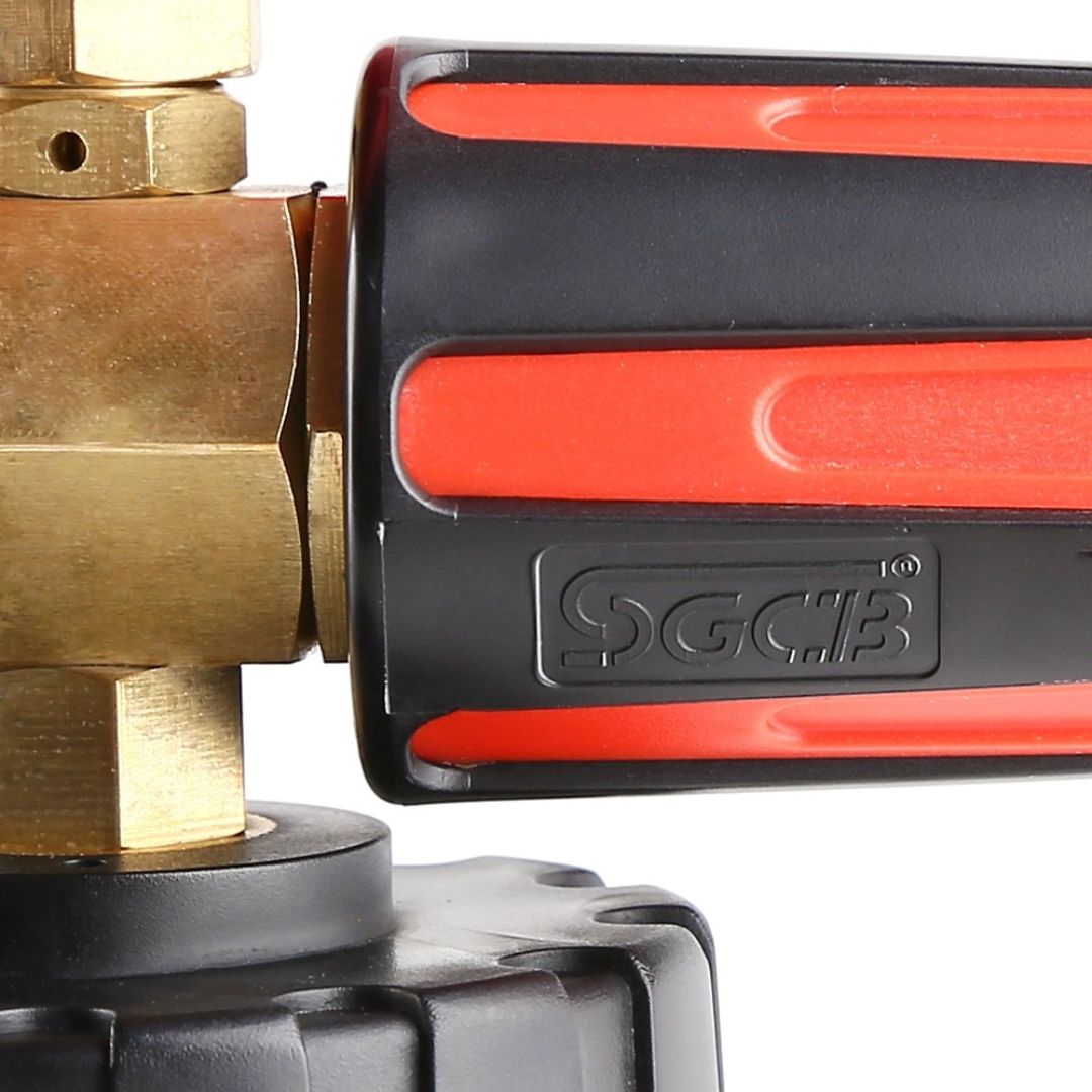Close-up of a brass valve and red and black tool with a visible brand logo on a white background.