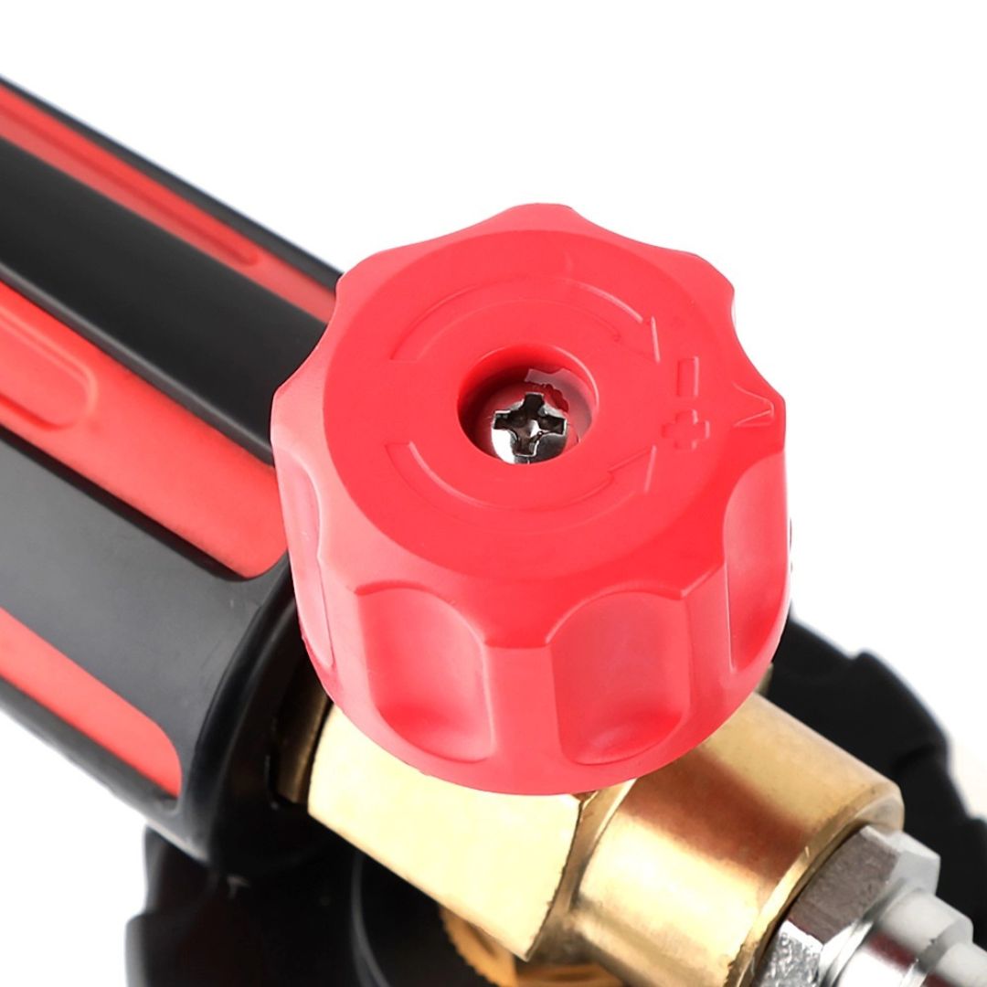 Close-up of a red valve handle on a pressure washer with a white background