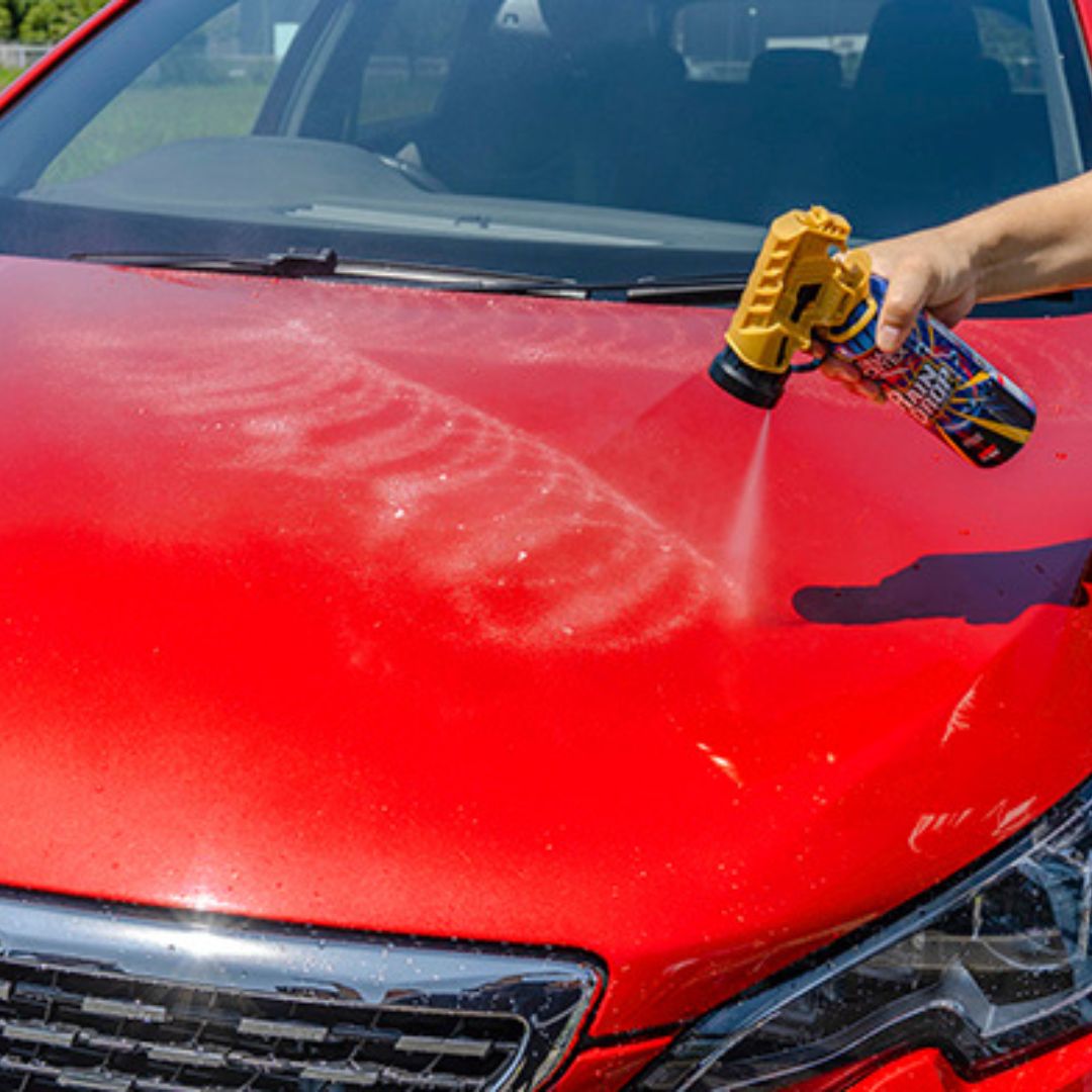 Spray can with gold top labeled 'Tornado Vortex' by Soft99 on red car