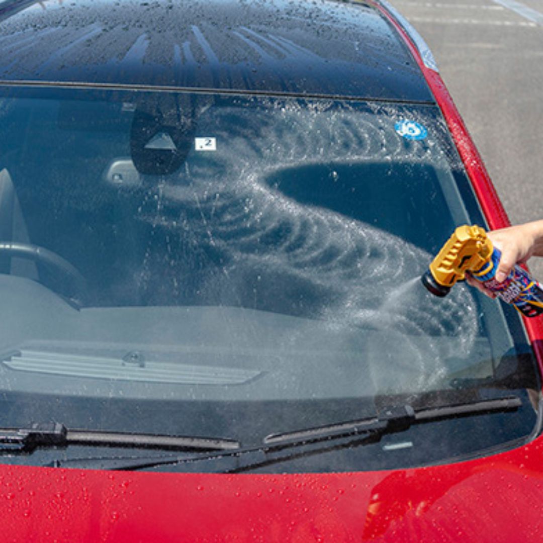 Spray can with gold top labeled 'Tornado Vortex' by Soft99 on windshield
