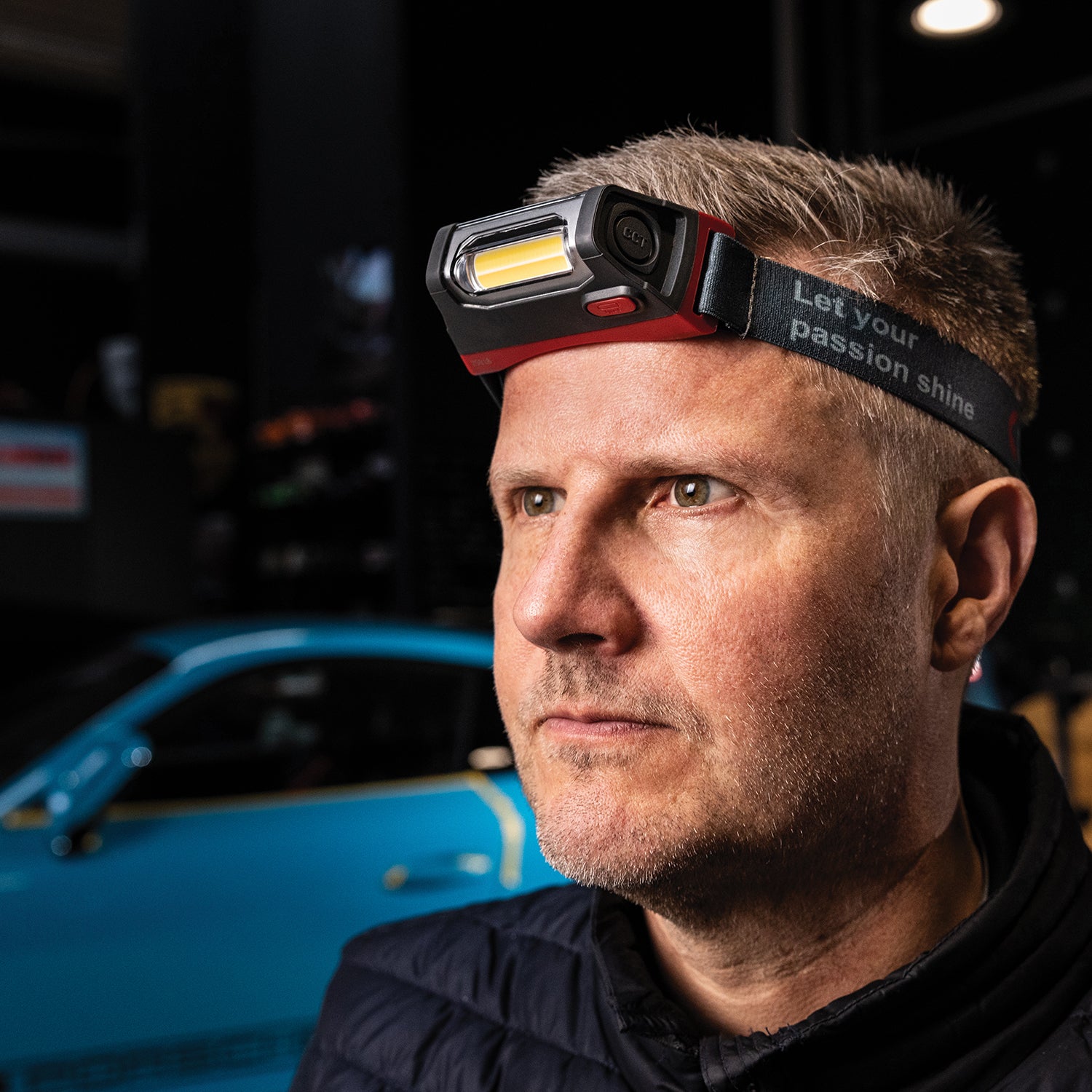 Scangrip I-Match 4  Man wearing a headlamp with a car in the background
