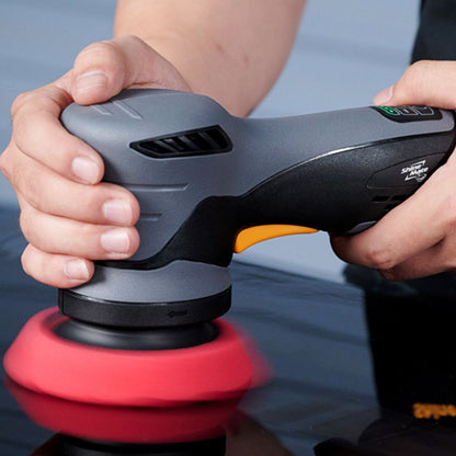 Person using a ShineMate EB212 Cordless Direct Drive 3" DA Polisher (12mm Throw) with a red pad on a blurred background