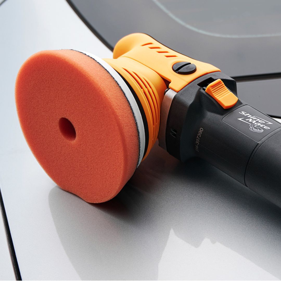 Shinemate ERO600 G2 Car polisher with orange pad on a car surface