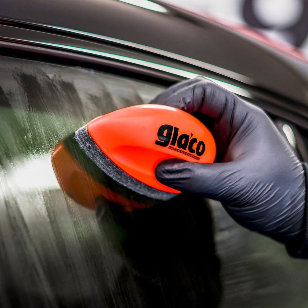 Person using a Glaaco Q car glass polish and sealant on a car window