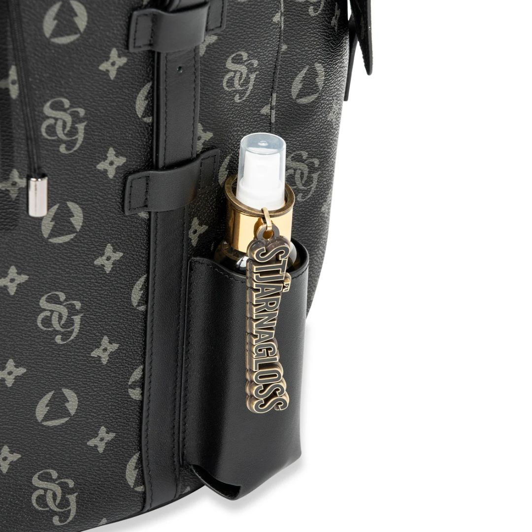 Black patterned bag with a gold and white lip balm holder featuring a brand logo.