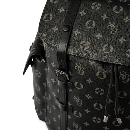 Black backpack with a patterned design on a white background