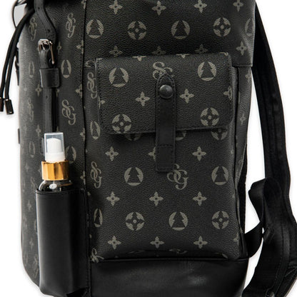 Black backpack with a pattern and a bottle next to it on a white background