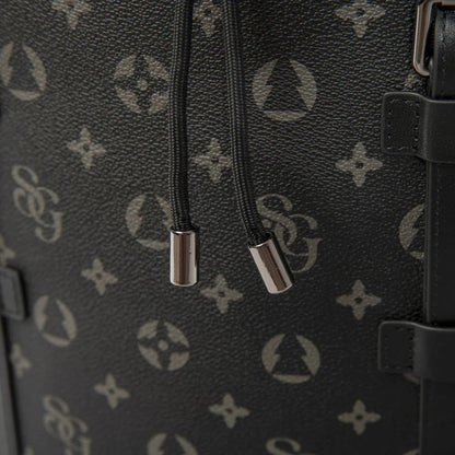 Close-up of a black textured bag with silver zippers and a brand logo.